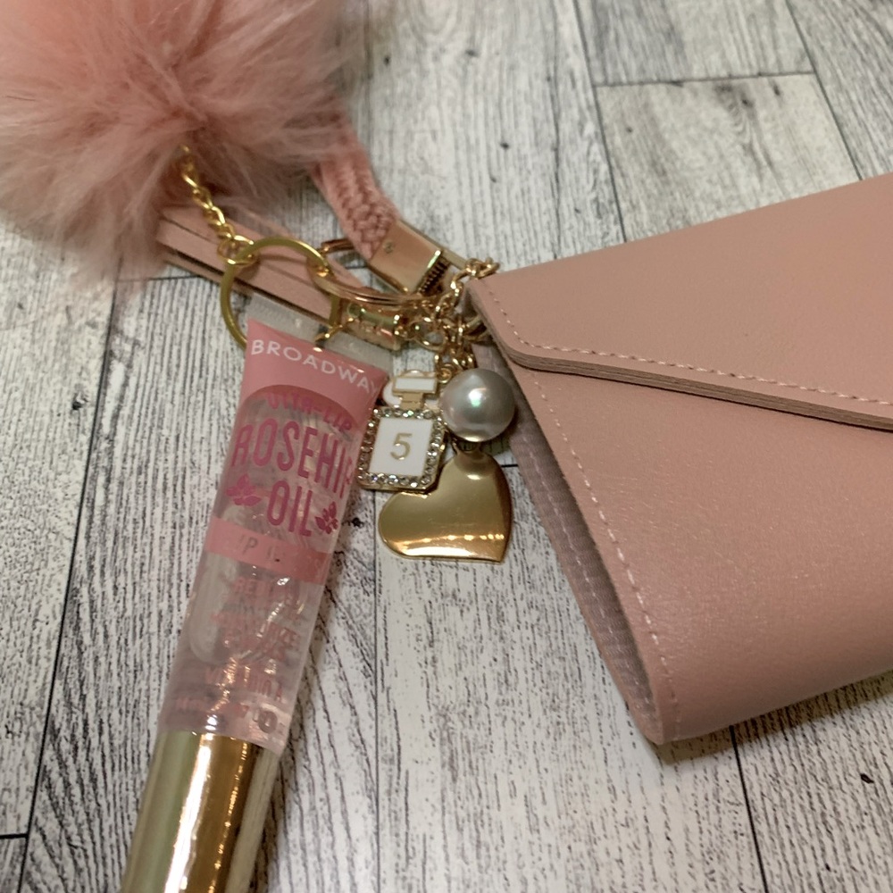 Pink keychain wallet with Broadway rosehip oil